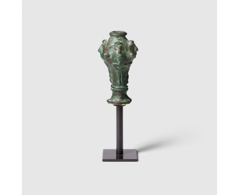 LURISTAN FIGURAL MACE EARLY 1ST MILLENIUM B.C. cast bronze, flaring base leading to a ringed collar, vertical ridges below a 