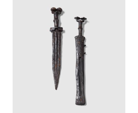 PAIR OF CELTIBERIAN DAGGERS IBERIA, IRON AGE, 500 - 300 B.C. cast iron, consisting of; one dagger with dual pommel, copper ba