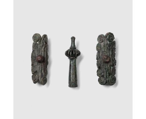 TRIO OF HELMET FITTINGS GREECE, 4TH - 2ND CENTURY B.C. cast bronze, comprising of; one helmet finial topped by a crown; a pai
