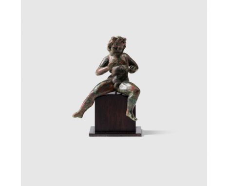 HELLENISTIC FIGURE OF A SATYR EUROPE, C. 1ST CENTURY B.C. cast bronze, the satyr of strong build, shown seated, as if perched