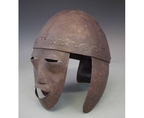 Iron helmet, the bowl of four piece construction with face mask and two ear guards engraved with triangle and circle patterns