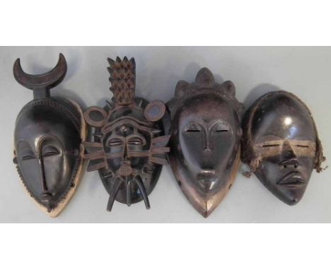 Two Yaure masks, a Senufo mask and a Dan mask, (4) the largest measures 31cm high     All lots in this Tribal and African Art