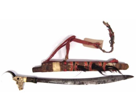 Dyak Mandau bone topped ceremonial sword, 67cm overall length in scabbard.       VAT is only payable on the Buyer's Premium f
