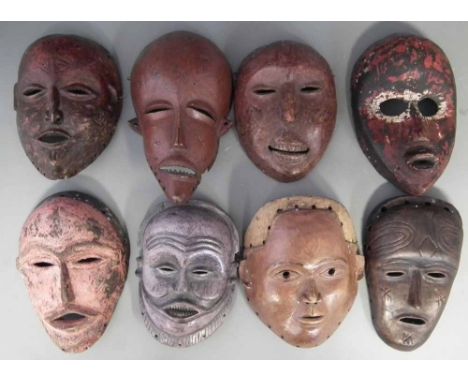 Eight African masks carved in various tribal styles, the largest mask measures 25cm high     All lots in this Tribal and Afri