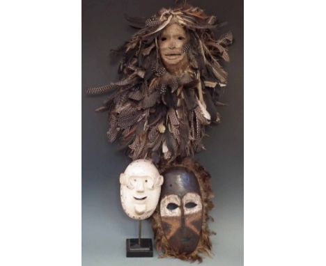 Chewa feather mask, another white painted mask possibly Chewa, and a Lombi mask, the largest mask measures 34cm excluding fea