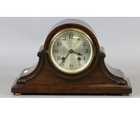An oak cased Napoleon's hat mantel clock. The Arabic numeral dial encloses eight day two train movement.