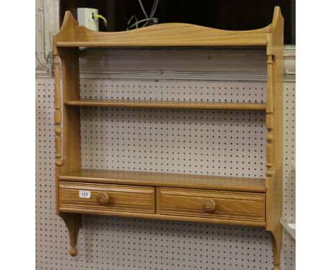 An Ercol two tier wall hanging plate rack.