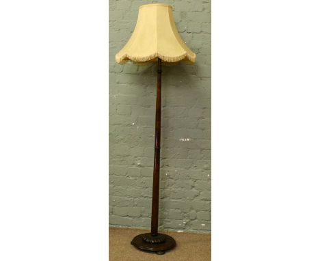 A turned mahogany standard lamp.