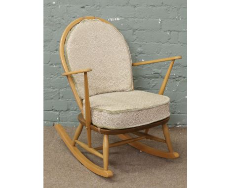 An Ercol rocking chair with spindle back. Cushions not included.