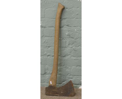 A long handled wood axe.