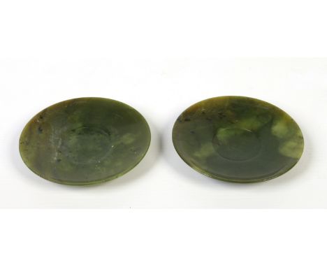 A pair of Chinese carved spinach jade saucers, 9.75cm diameter.  Condition Report. To be used as a guide only. Good condition