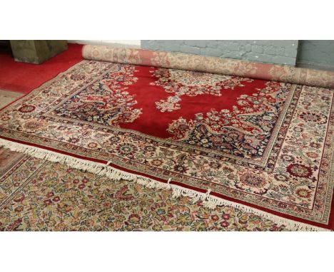 A large Super Keshan wool carpet, red ground and with a medallion design, 275 x 360cm.