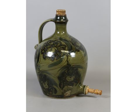 A Winchcombe studio pottery cider flagon with scrolling strap handle green glazed and decorated with stylized flowers. Condit