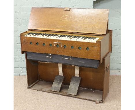 A Salvation Army travelling harmonium in case and with canvas cover.