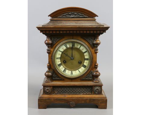 A C19th mahogany mantel clock with Roman numeral enamel dial enclosing twin train movement.