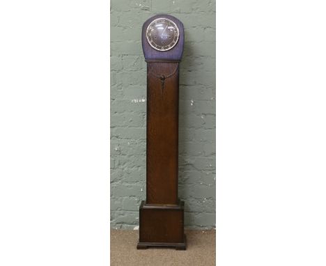 An oak cased Smiths Westminster chime granddaughter clock complete with pendulum, key and original guarantee dated 1946.