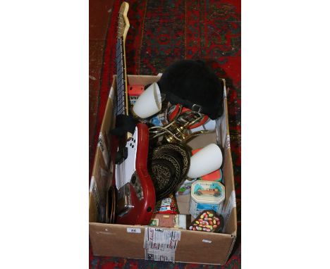 A box of miscellaneous including a brass lamp, advertising tins, metalwares and a riding hat etc.