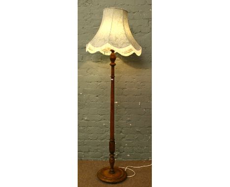A carved and turned oak standard lamp and shade.