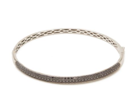 A EMBELLISHED BLACK DIAMOND BANGLE
From a Singapore single-owner collection. Coming in October, from the same owner, 'The Fas