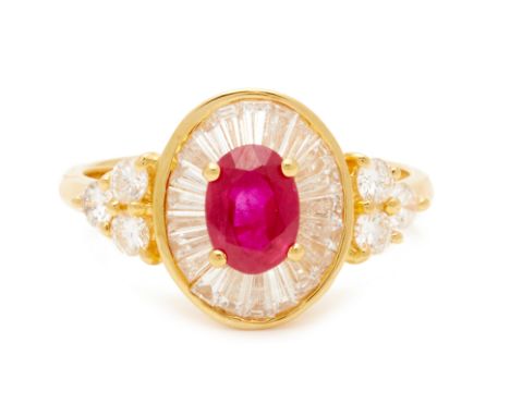 AN OVAL RUBY AND DIAMOND RING
An oval step cut ruby ring set in approx. 20k yellow gold with tapered baguette diamonds to the