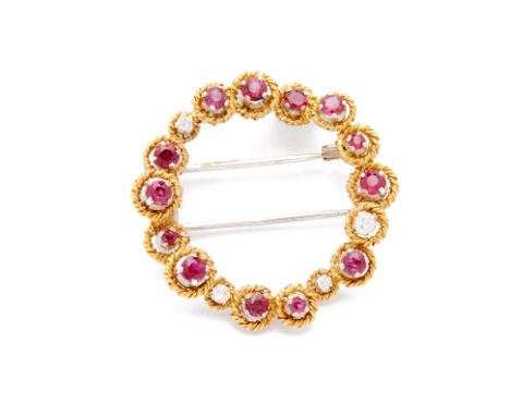 A RUBY AND DIAMOND BROOCH A circular brooch embellished with rubies and diamonds in a rope twist setting
 Diameter 3.4cm 9.27