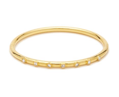A YELLOW GOLD AND DIAMOND BANGLE A gold bangle set with seven emerald and square cut diamonds  Approx. weight diamonds: 0.34c