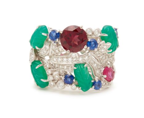 A 'TUTTI FRUTTI' WHITE GOLD RING An 18k white gold band with a ruby, red garnet, sapphires, diamonds and carved leaf green ag