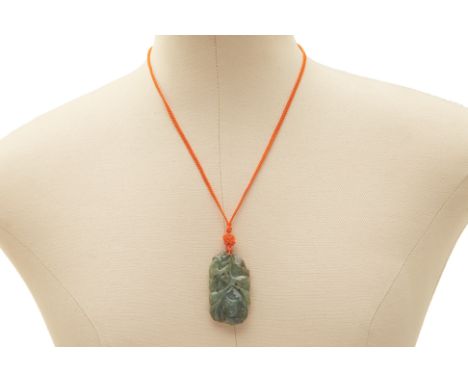A JADE PENDANT WITH FOLIATE CARVING A jade pendant with floral carving on an orange material chain
 5cm long 23g