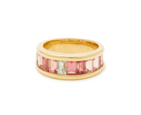 A SEVEN STONE TOURMALINE RING An 18k yellow gold band with square, step cut tourmalines
Marked 750 Hong Kong size 16