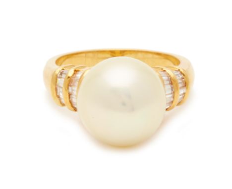 A 20K YELLOW GOLD, PEARL AND DIAMOND RING An 850k yellow gold band with a central pearl flanked by tapered baguette cut diamo