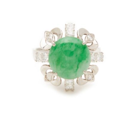 A CABOCHON JADE AND DIAMOND RING An 18k white gold band with central cabochon jade surrounded by round cut diamonds in a foli