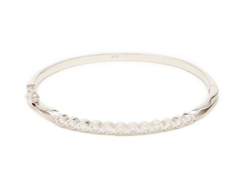 A WHITE GOLD AND DIAMOND BANGLE A 18k white gold bangle with 12 brilliant round cut diamonds and box clasp
Approx. weight dia