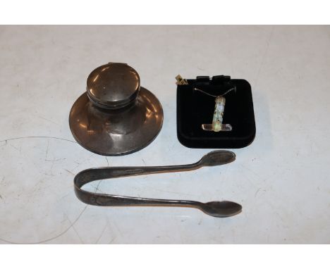 A opal coloured silver mounted pendant hung to a silver fine link chain; and a pair of silver sugar tongs and a silver inkwel