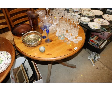 A circular pine pedestal dining table with a set of three ladder back chairs and one oak ladder back chair 