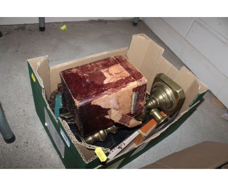 A box containing brass candlesticks; carriage clock travelling case etc.
