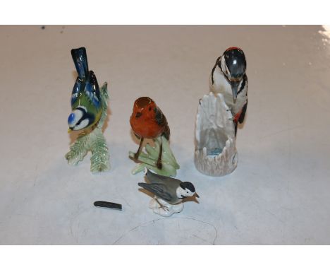 A Goebel robin; a Goebel blue tit; a Goebel great spotted woodpecker; and a Goebel white wagtail AF