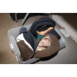 A box containing various military hats and helmets