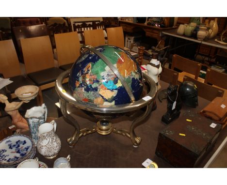 A large mother of pearl and gemstone inset globe on stand