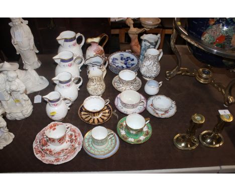 A graduated set of Coalport "Caughley" mask head jugs; three various other floral patterned jugs; various bone china tea cups