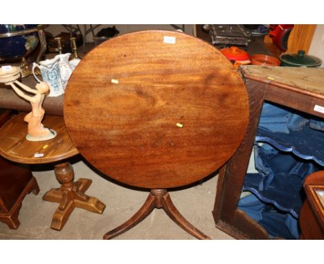 A 19th Century oak snap top table raised on tripod base 