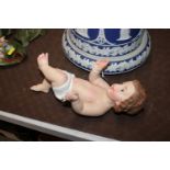 A painted and decorated cherub figure, 28cm