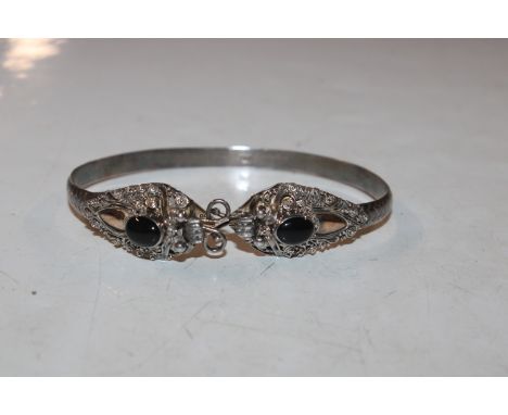 A 925 Sterling silver bangle set with black stones, approx. 16.6gms 