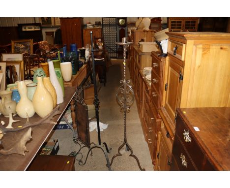 A wrought iron candle holder and a wrought iron standard lamp