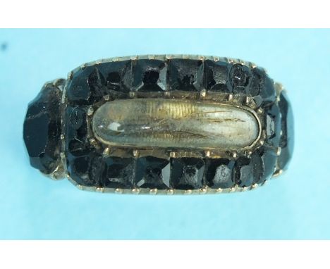 A Georgian mourning ring with crystal locket within jet frame, inscription to reverse dated 1811, size N, 3.3g, (a/f).