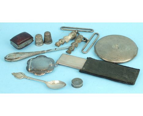 A small silver flower-shaped compact, an engine-turned compact, an engine-turned silver-mounted comb with cover and other ite