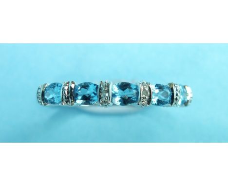 A blue topaz and diamond point half-hoop ring with 9ct white gold mount, size P, 2g.