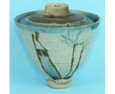 A studio pottery bowl and cover decorated with stylised landscapes and figures, signed 'E J Melton, Elm Ash', dated 1972.