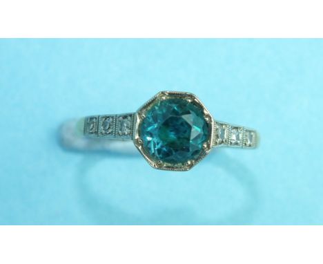 An 18ct gold and platinum ring set blue zircon between diamond-set shoulders, size N, 2.3g.