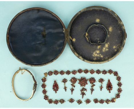 A Victorian Bohemian garnet-set hinged bangle and a gilt-mounted garnet cluster fringe necklace, (all a/f), (2).
