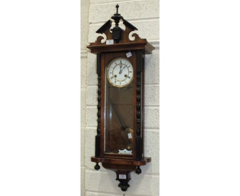 A Vienna-style stained wood wall clock with gong-striking twin-trained movement and two-piece white enamel dial, 97cm high.